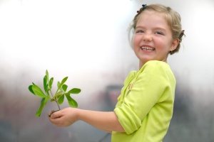 little girl holding small plant